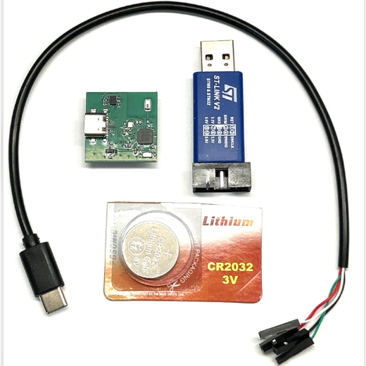 Everything in the kit: the CyborgCore board, the coin battery, the USB-C cable and the ST-Link V2 programmer